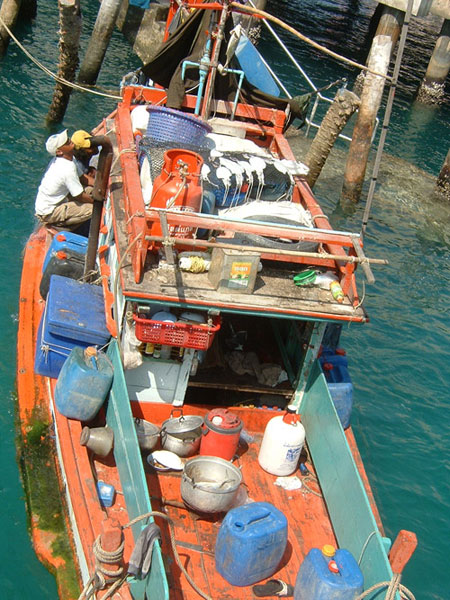 A small fishing boat moored at a pier, at an  island in Chonburi, Gulf of Thailand