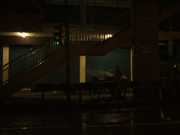 A street hawker at night